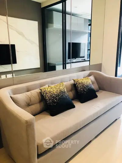 Modern living room with stylish sofa and decorative pillows in a contemporary apartment.