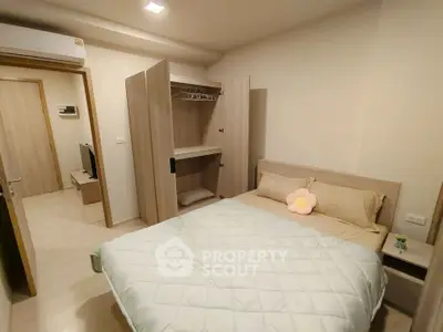 Cozy bedroom with modern furnishings and ample storage in a stylish apartment.