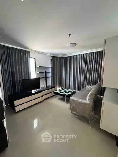 Modern living room with sleek furniture and large windows in a stylish apartment.