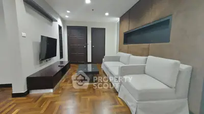 Spacious modern living room with elegant parquet flooring and cozy seating area.