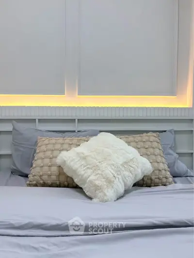 Luxurious bedroom with elegant lighting and plush pillows for ultimate comfort.