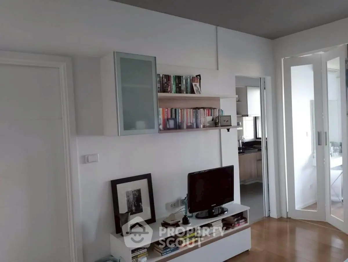 Modern living room with sleek furniture and built-in shelving, showcasing a stylish and functional space.