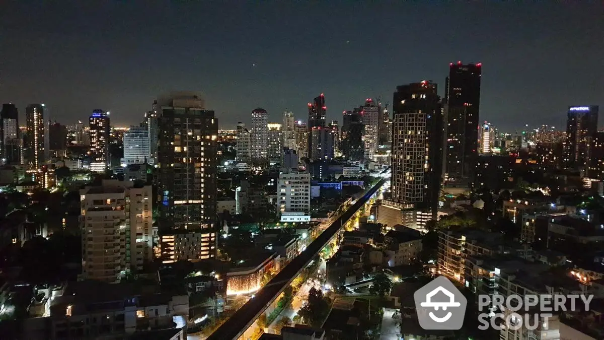 Stunning night view of city skyline with illuminated skyscrapers and vibrant urban landscape.