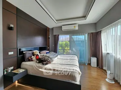 Luxurious bedroom with large windows and modern decor, featuring plush bedding and ample natural light.