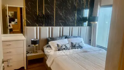 Luxurious bedroom with elegant decor and large window for natural light.