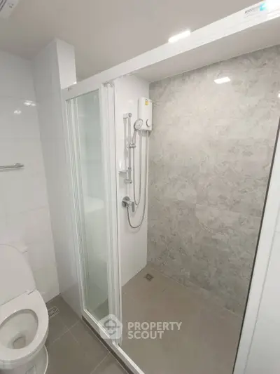 Modern bathroom with sleek shower enclosure and tiled walls