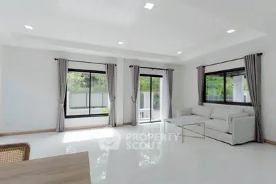 Spacious modern living room with large windows and elegant decor
