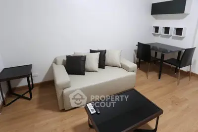 Modern living room with sleek furniture and wooden flooring, perfect for urban living.