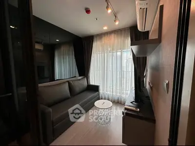 Modern living room with sleek sofa and floor-to-ceiling windows in a stylish apartment.
