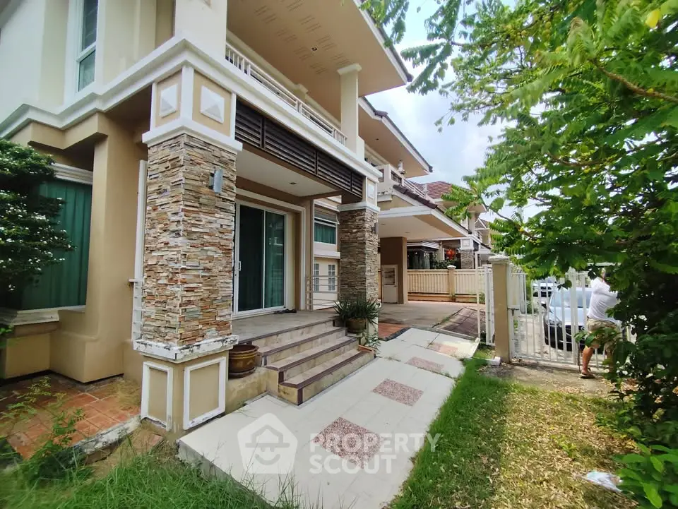 Charming suburban home with stone accents and lush greenery, perfect for family living.