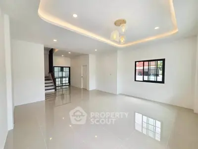Spacious modern living room with glossy tile flooring and elegant ceiling lights