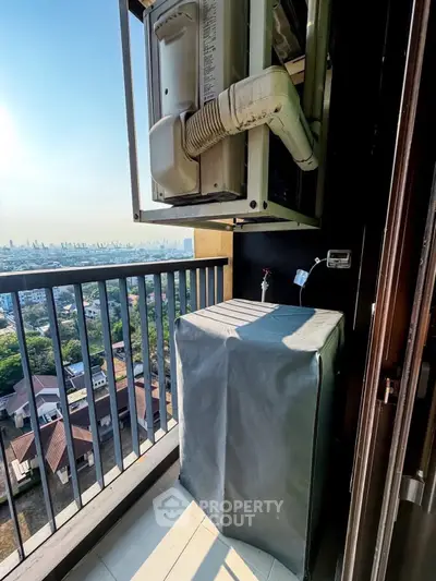 High-rise balcony with city view and air conditioning unit