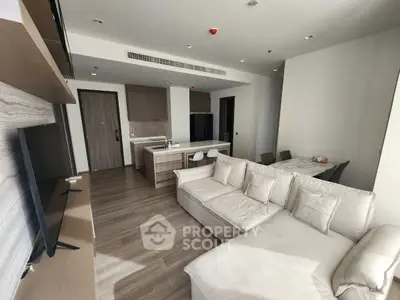 Modern living room with open kitchen and stylish furniture in a bright apartment