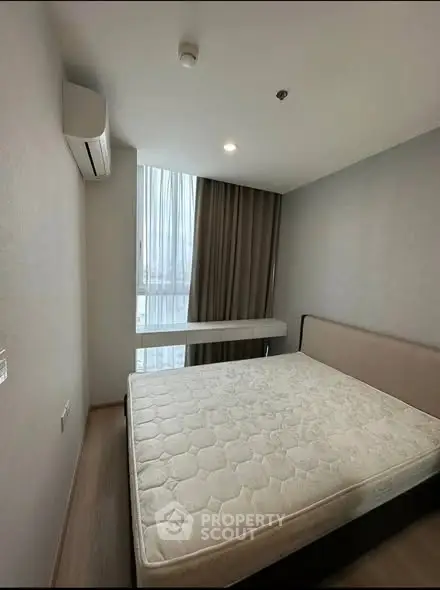 Cozy bedroom with large window and modern air conditioning unit