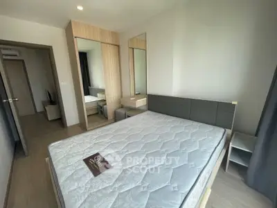 Modern bedroom with stylish furniture and large mirror, perfect for a cozy living space.