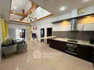 Spacious open-plan kitchen and living room with modern design and natural light.