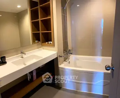 Modern bathroom with bathtub and sleek vanity in contemporary apartment