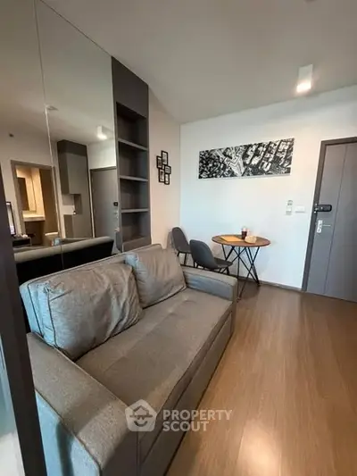 Modern living room with stylish decor and cozy seating in a contemporary apartment.