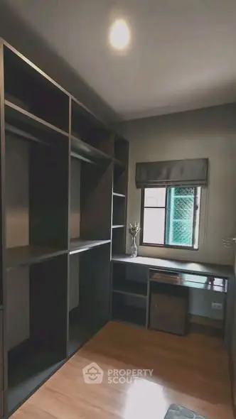 Spacious study room with built-in shelves and natural light