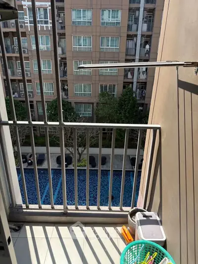 Charming balcony with pool view in modern apartment complex