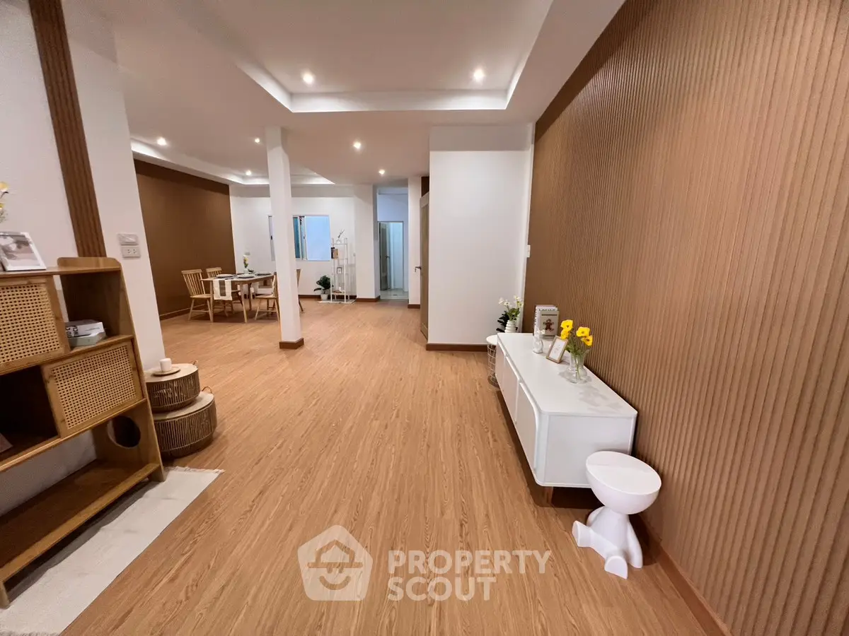 Spacious modern living room with elegant wood flooring and stylish decor