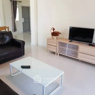 Modern living room with sleek furniture and TV, perfect for relaxation and entertainment.