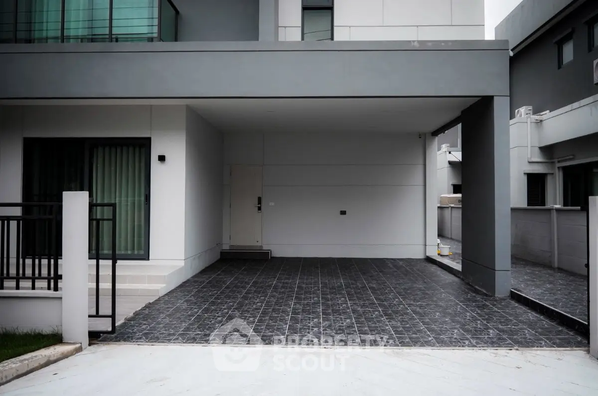 Modern minimalist house exterior with sleek design and spacious driveway