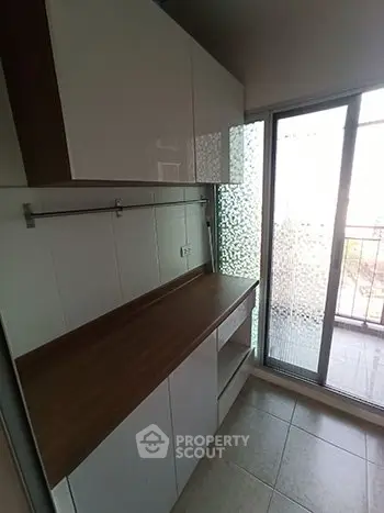 Modern kitchen with sleek cabinets and balcony access