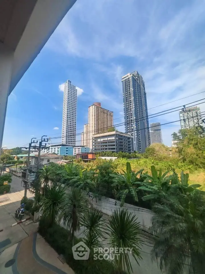 Stunning cityscape view with modern high-rise buildings and lush greenery, perfect for urban living enthusiasts.