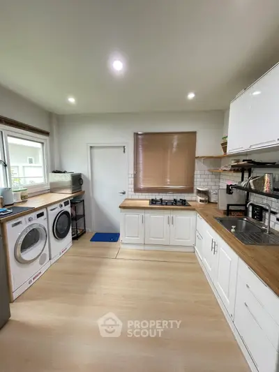 Modern kitchen with wooden countertops and built-in appliances