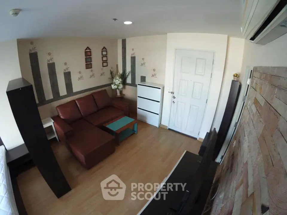 Cozy living room with modern decor and comfortable seating in a stylish apartment.