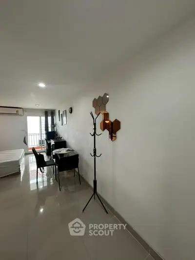 Modern apartment interior with sleek design and natural light, featuring a dining area and stylish decor.