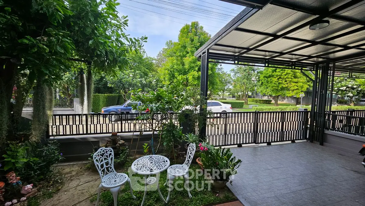 Charming garden patio with white furniture and lush greenery
