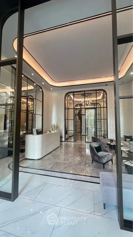 Luxurious modern lobby with elegant marble flooring and chic seating area in upscale building.