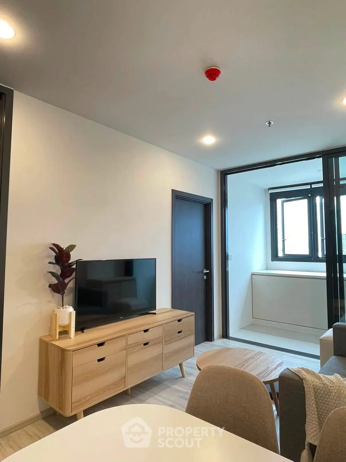 Modern living room with sleek furniture and natural light, perfect for urban living.