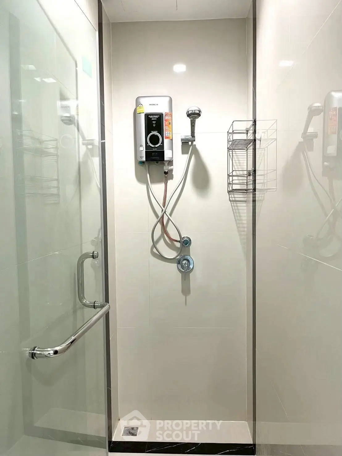 Modern bathroom shower with sleek glass enclosure and wall-mounted water heater.
