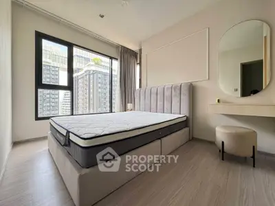 Modern bedroom with large windows and stylish decor in a high-rise apartment.