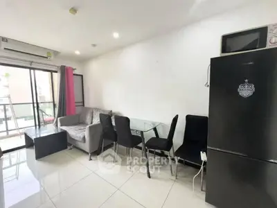 Modern living room with balcony access, featuring sleek furniture and a spacious layout.