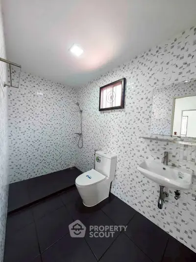 Modern bathroom with sleek tiles and walk-in shower