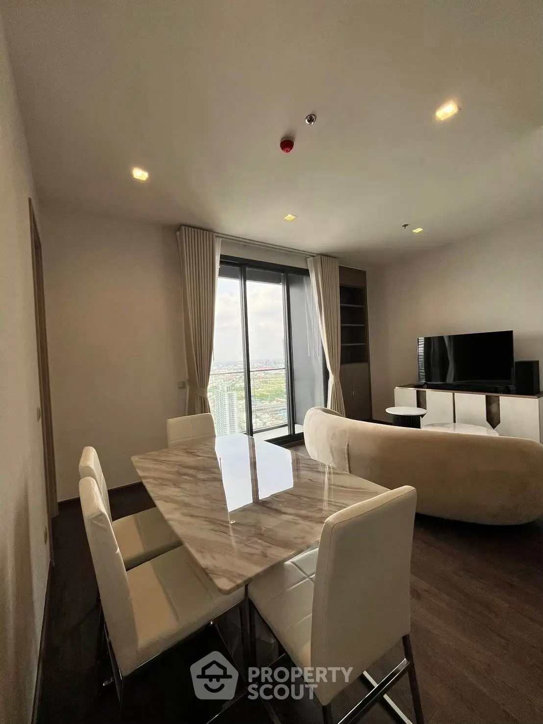 Modern living room with elegant dining area and stunning city view