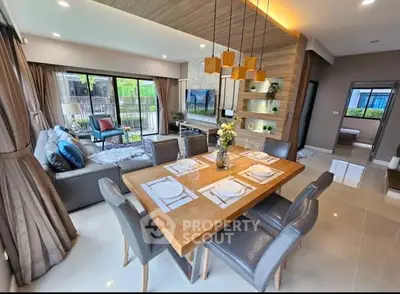 Luxurious open-plan living and dining area with modern decor and large windows for natural light.