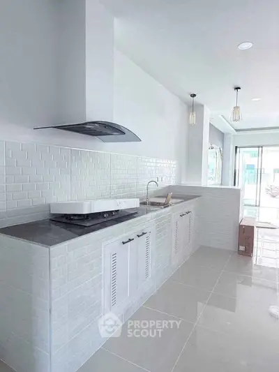 Modern kitchen with sleek white cabinetry and open layout design