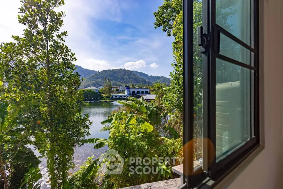 Stunning lake view from open window in serene residential area