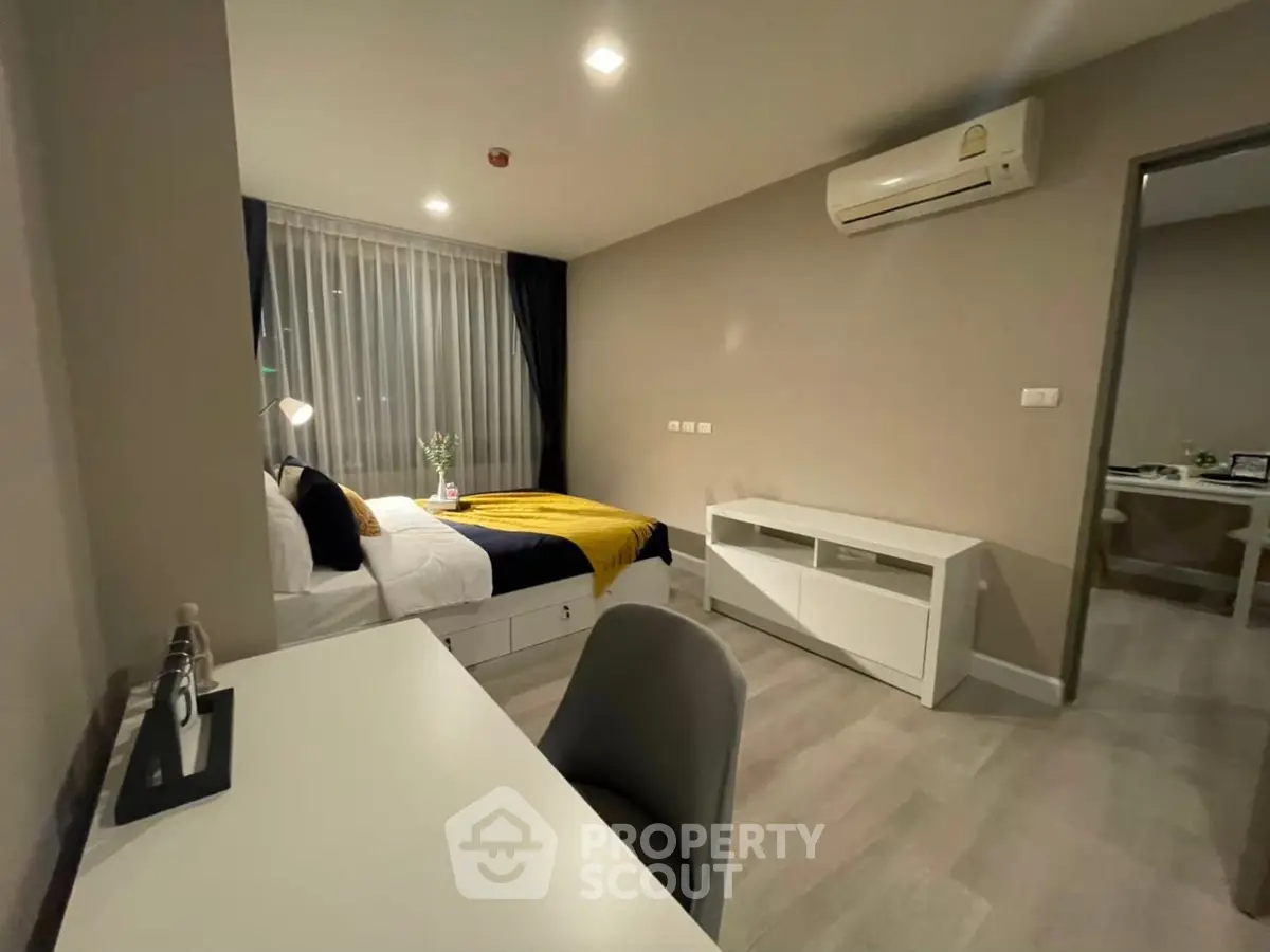 Modern bedroom with stylish decor and air conditioning in a cozy apartment.