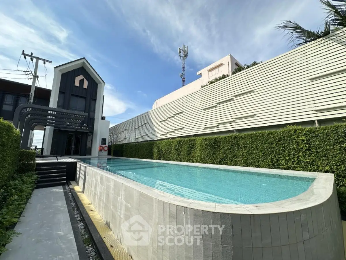 Modern property with sleek pool and lush greenery, perfect for luxury living.