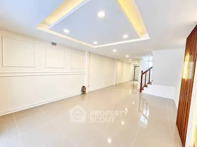 Spacious modern living room with elegant ceiling lights and glossy tiled flooring