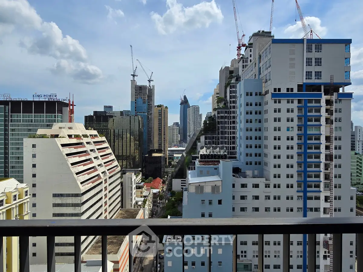 Stunning cityscape view from a high-rise balcony showcasing modern architecture and urban skyline.