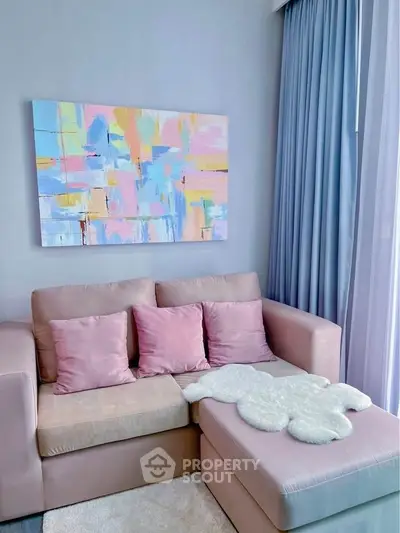 Chic living room with pastel decor and abstract art, perfect for modern urban living.