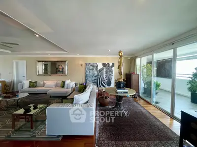 Luxurious living room with elegant decor and spacious balcony access