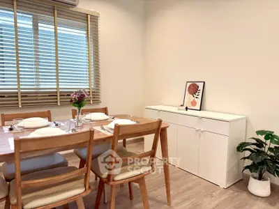 Charming dining area with wooden furniture and natural light, perfect for cozy family meals.